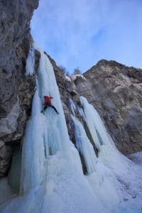 Ice climber Vern Nelson Jr. climbing in a majestic WI5 formation in Cody Wyoming.