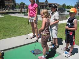 Family Playing Miniature Golf