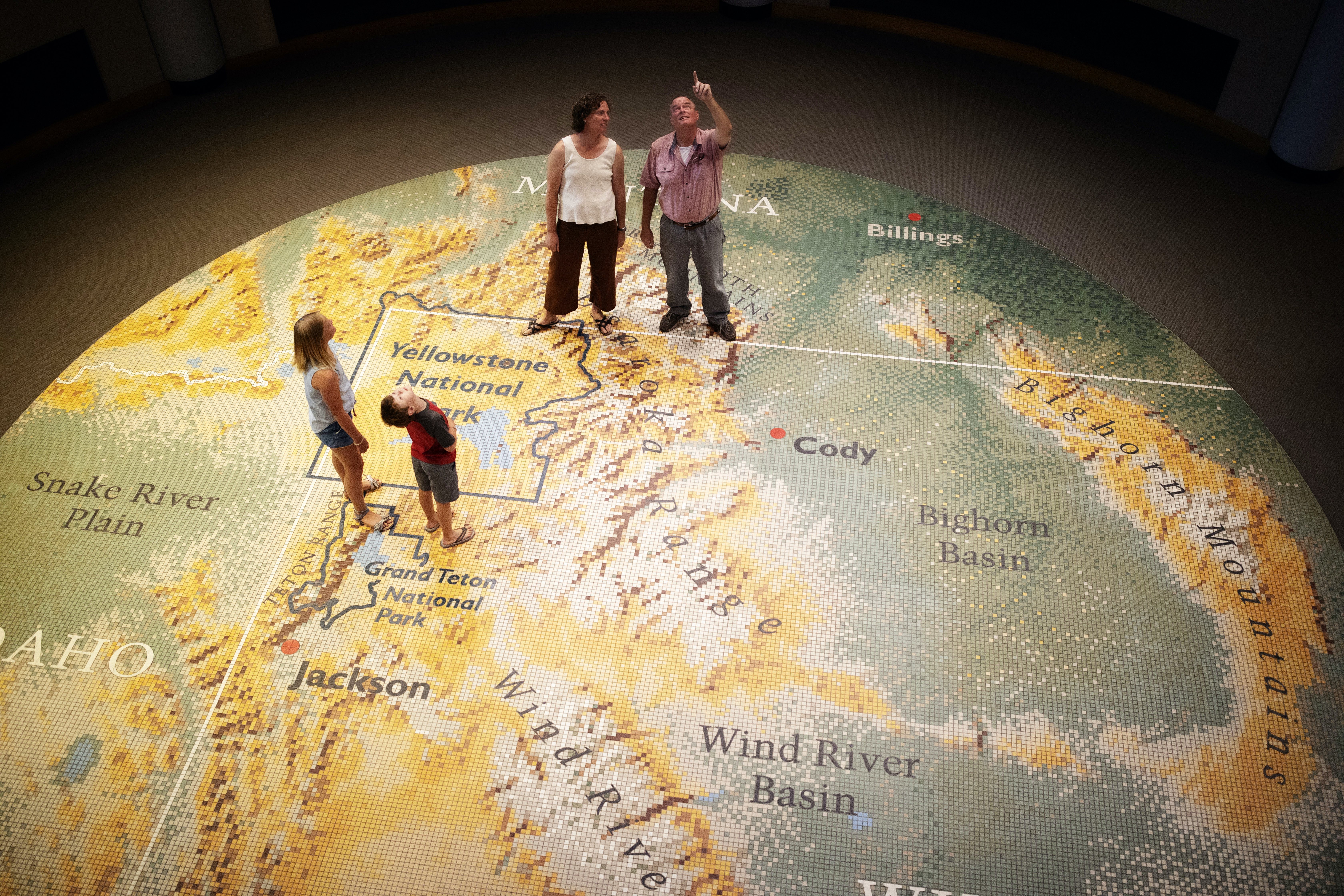 Visitors stand on a giant map in the Buffalo Bill Center of the West