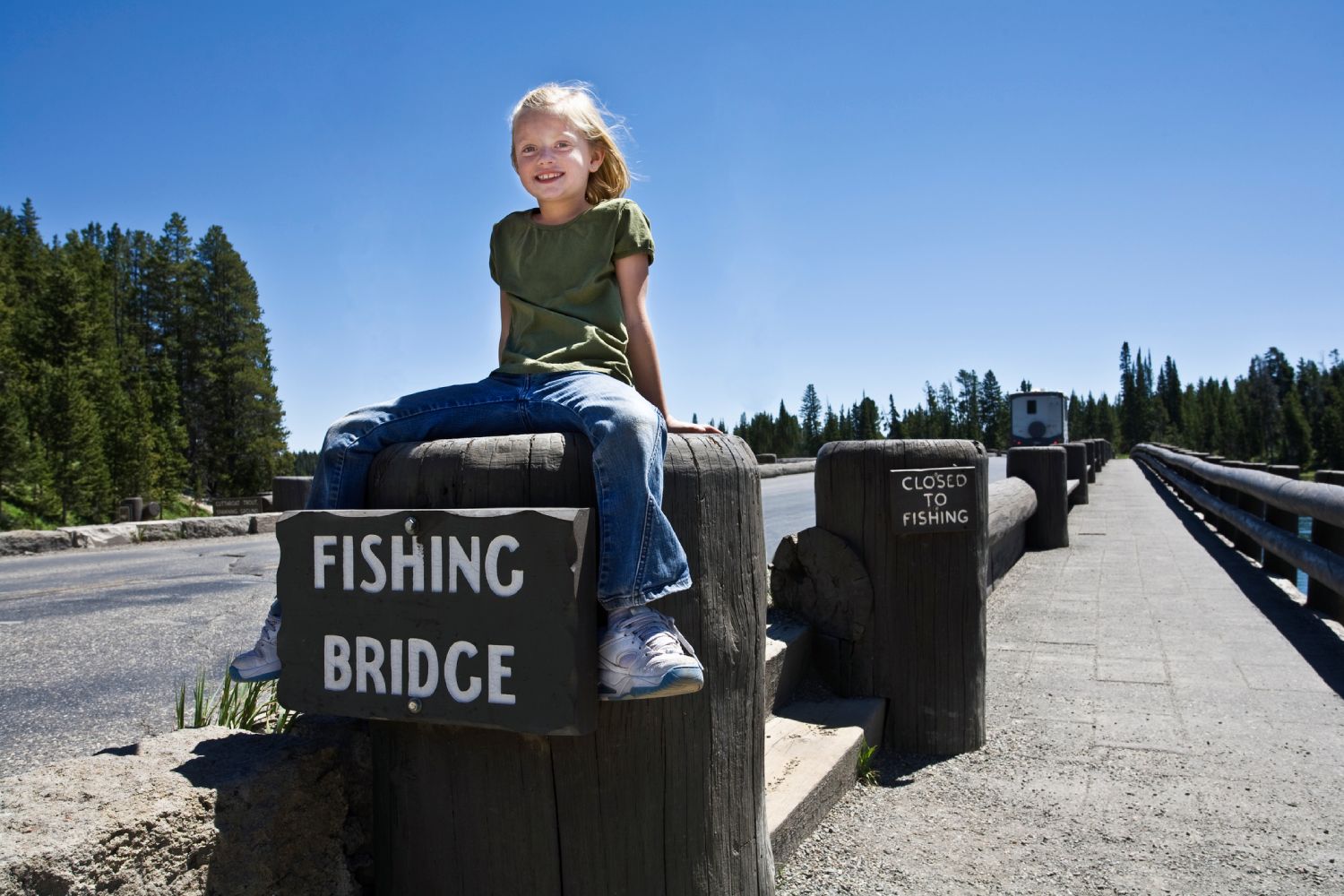 A child sits on the Fishing Bridge in Yellowstone National Park