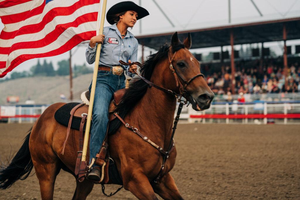 A woman rides a horse at the rodeo in Cody Yellowstone