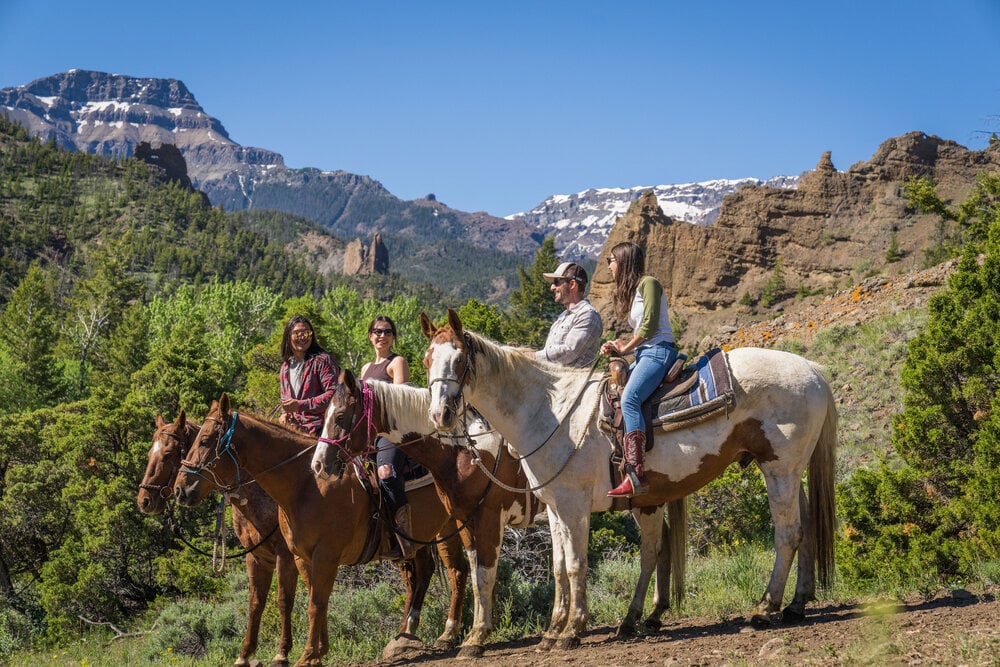 Friends take a horseback ride in Cody Yellowstone