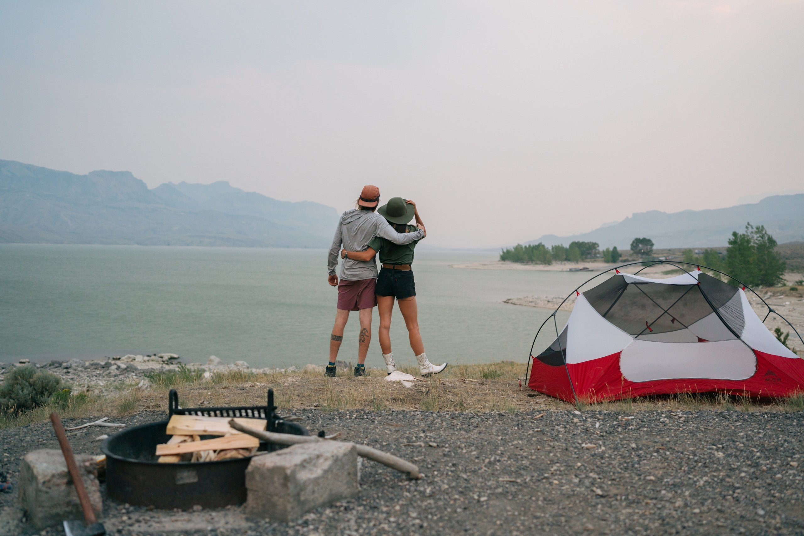 A man and woman stand arm in arm at their camp site in Cody Yellowstone