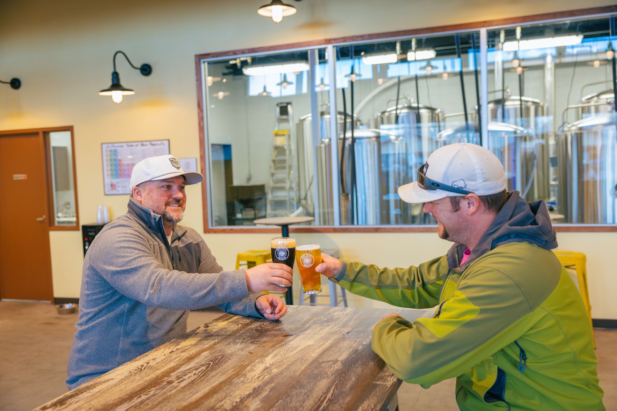 Two men toast at Cody Craft Brewing in Cody Yellowstone