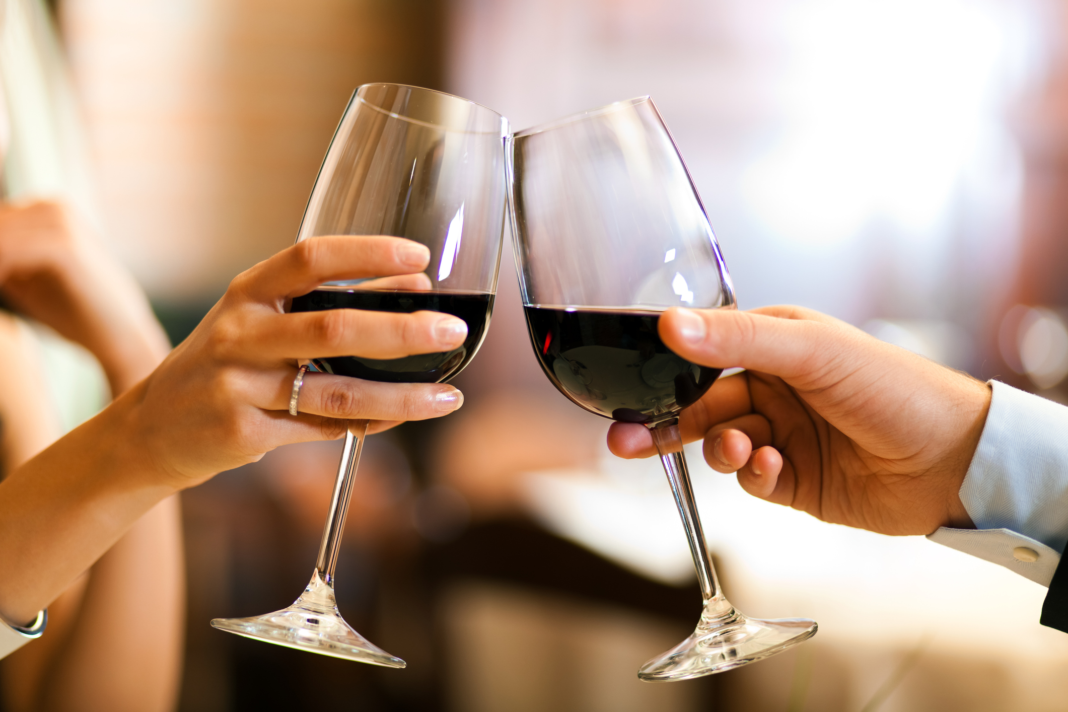 Couple toasting wine glasses in a restaurant