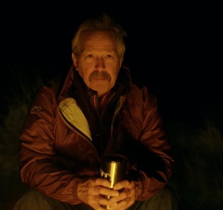 Tim Wade sitting in front of a fire