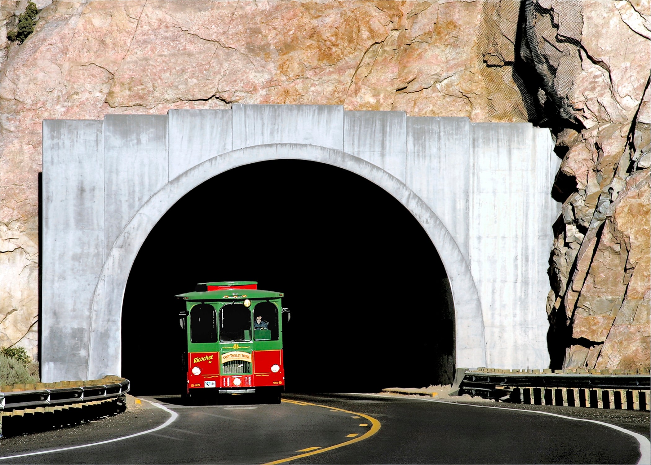 Cody Trolley emerging from a tunnel carved into the mountain