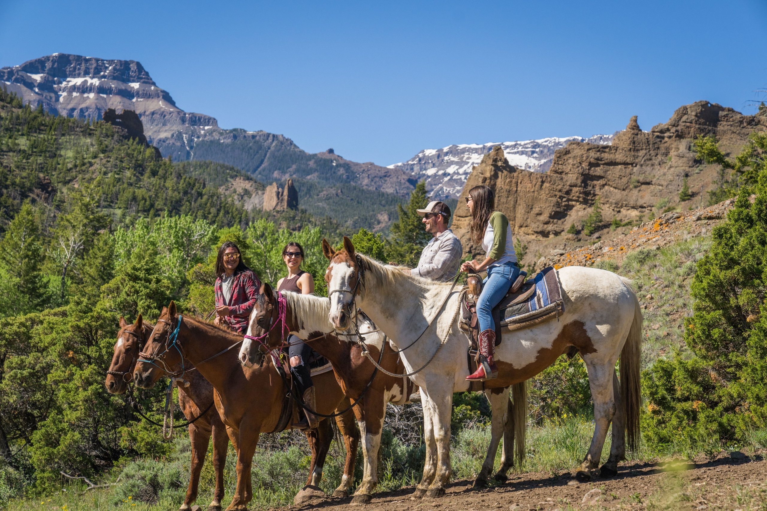 a family riding horses in the mountains