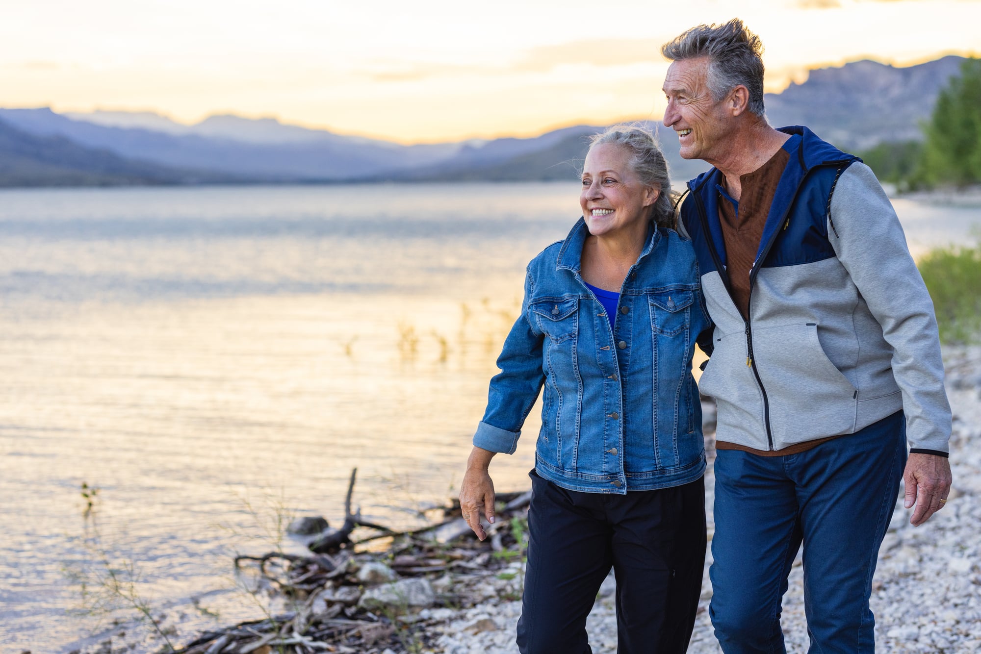 A mature couple walks along Buffalo Bill Reservoir at dusk