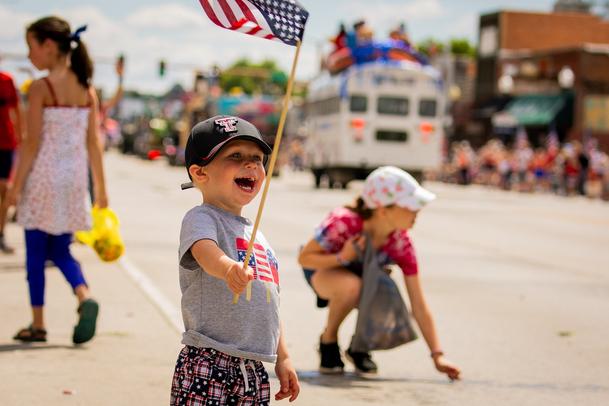 A child waving an American flag at the July 4th parade in Cody Yellowstone