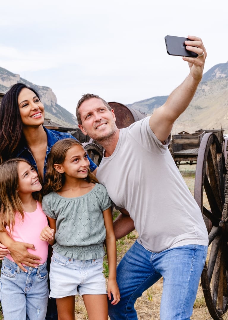 A family poses for a photo at Old Trail Town in Cody Yellowstone