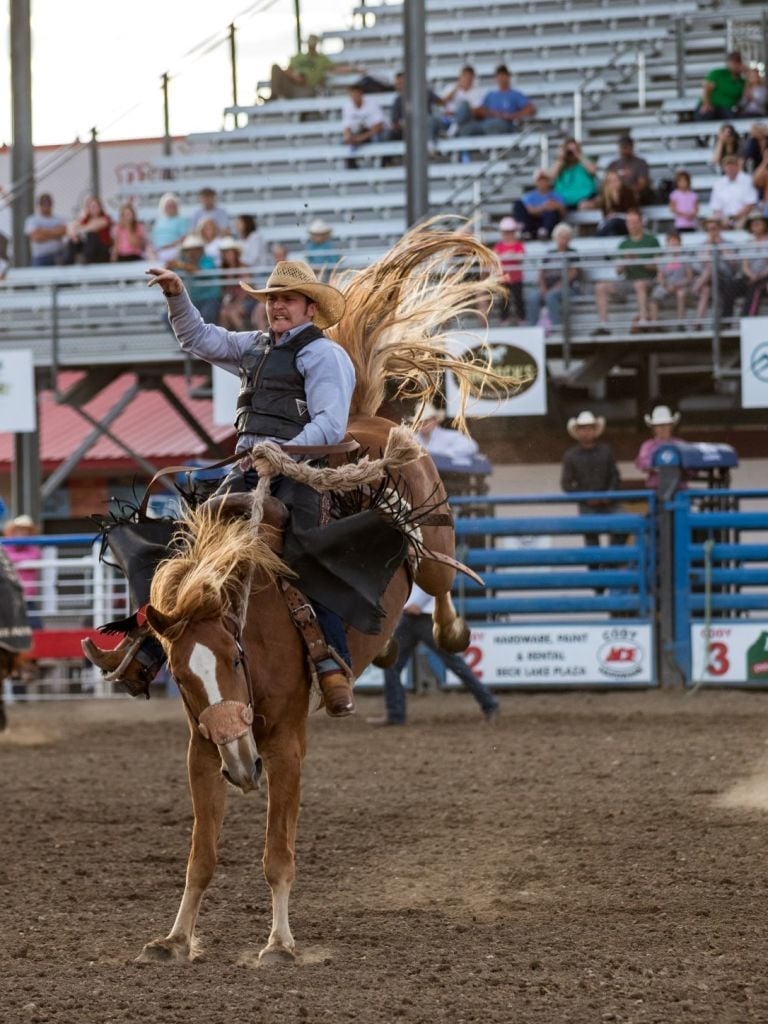 A man riding a horse at a stampede
