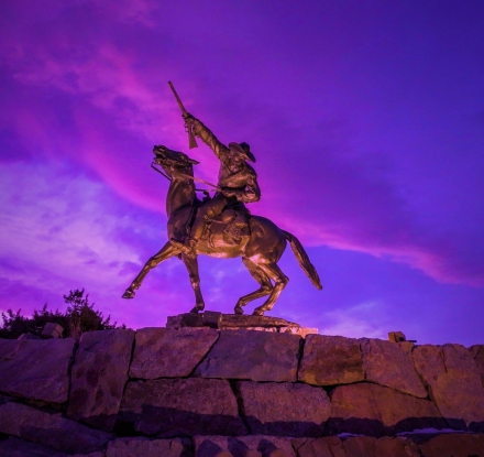 A dramatic photo of the Buffalo Bill Cody Scout statue near Buffalo Bill Center of the West in downtown Cody Yellowstone