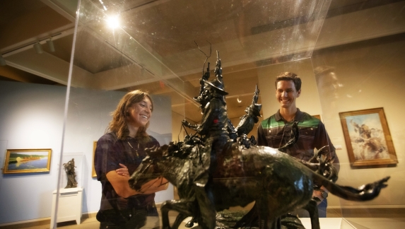 Two people look at a sculpture in the Buffalo Bill Center of the West