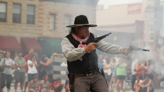A gun fighter performs for a crowd in Cody Yellowstone