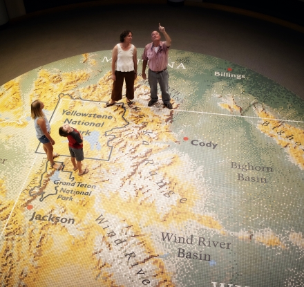 Visitors stand on a giant map in the Buffalo Bill Center of the West