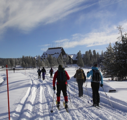 Cross country skiers head toward The Old Faithful Inn at Yellowstone