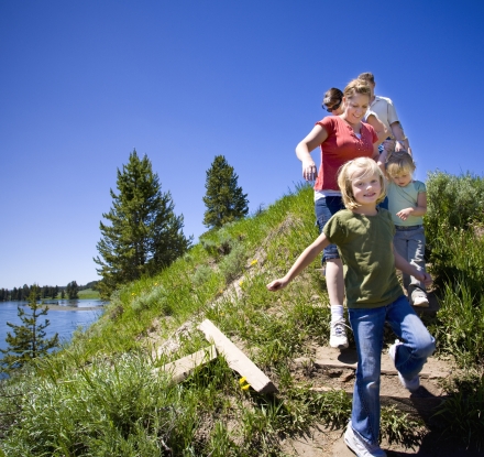 Kids walking with parents through Yellowstone National Park